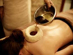 a person is receiving Greeva basti an Ayurvedic massage especially for neck pain and cervical spondylosis.  